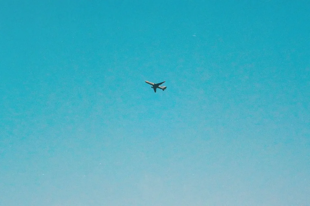 Airplane flying through blue sky