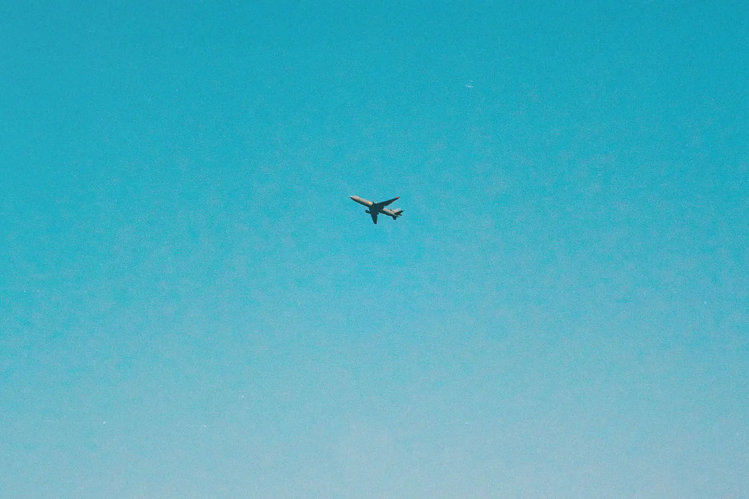 Airplane flying through blue sky
