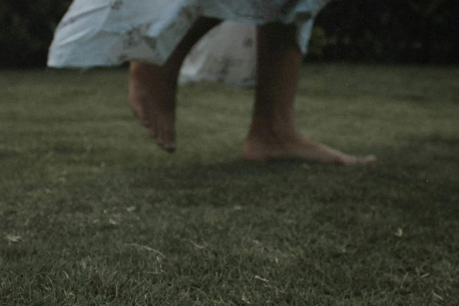 Close up of feet running on grass