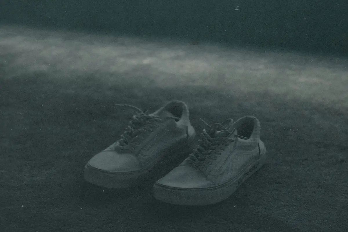 A pair of empty shoes on the ground