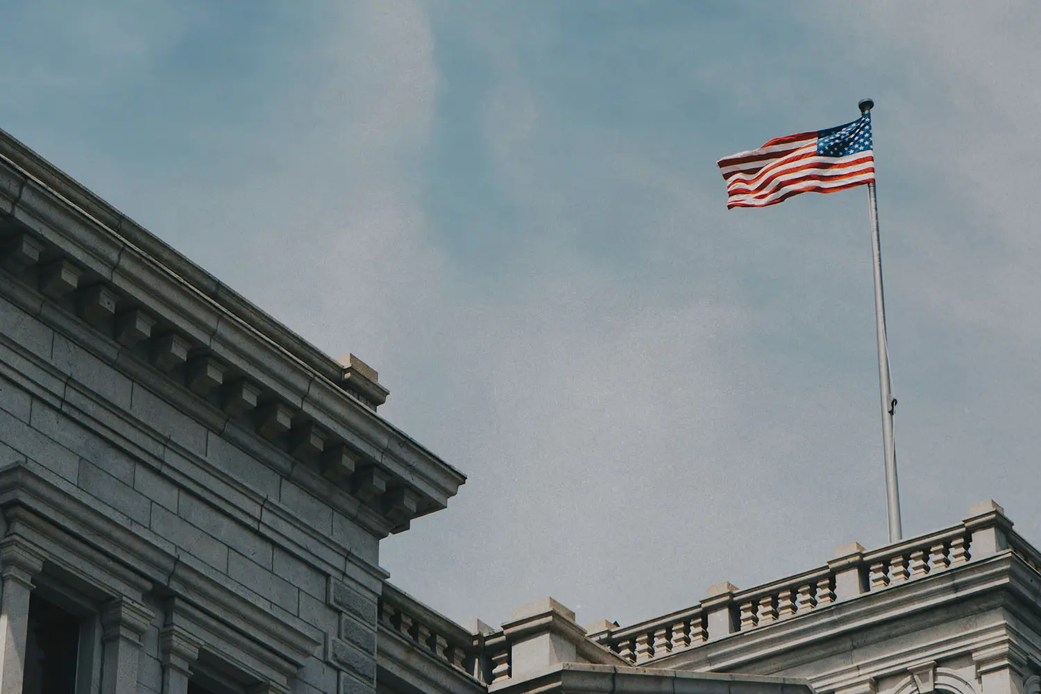 flag flying on top of a white building