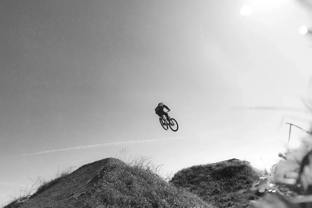 mountain biker jumping a hill