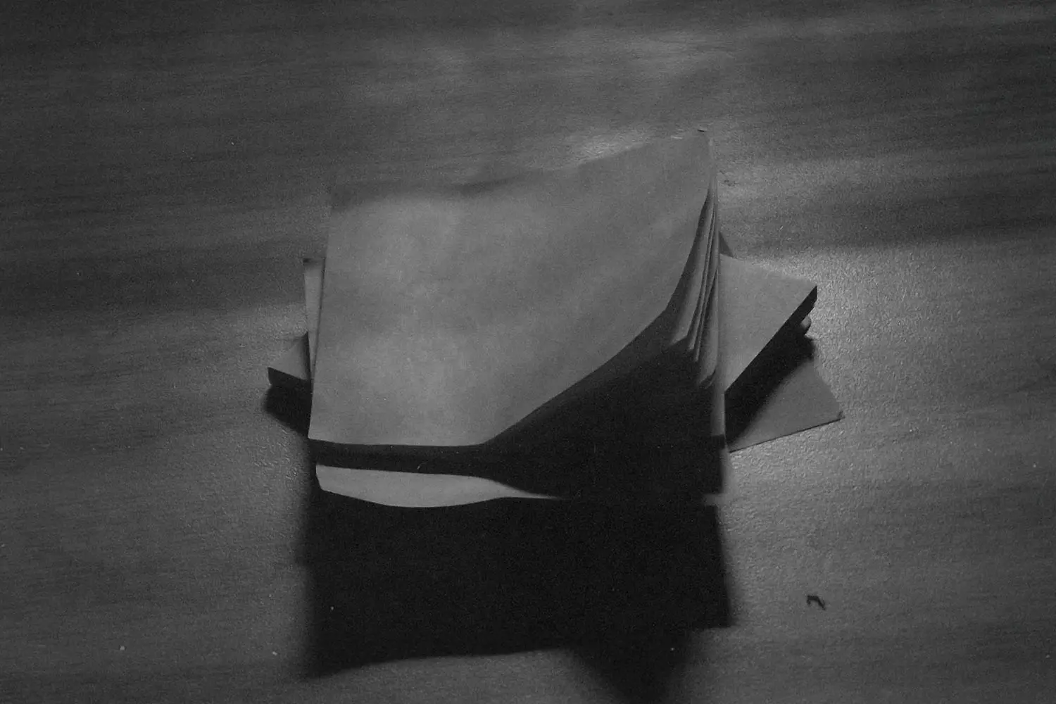 Stack of papers on a wooden table