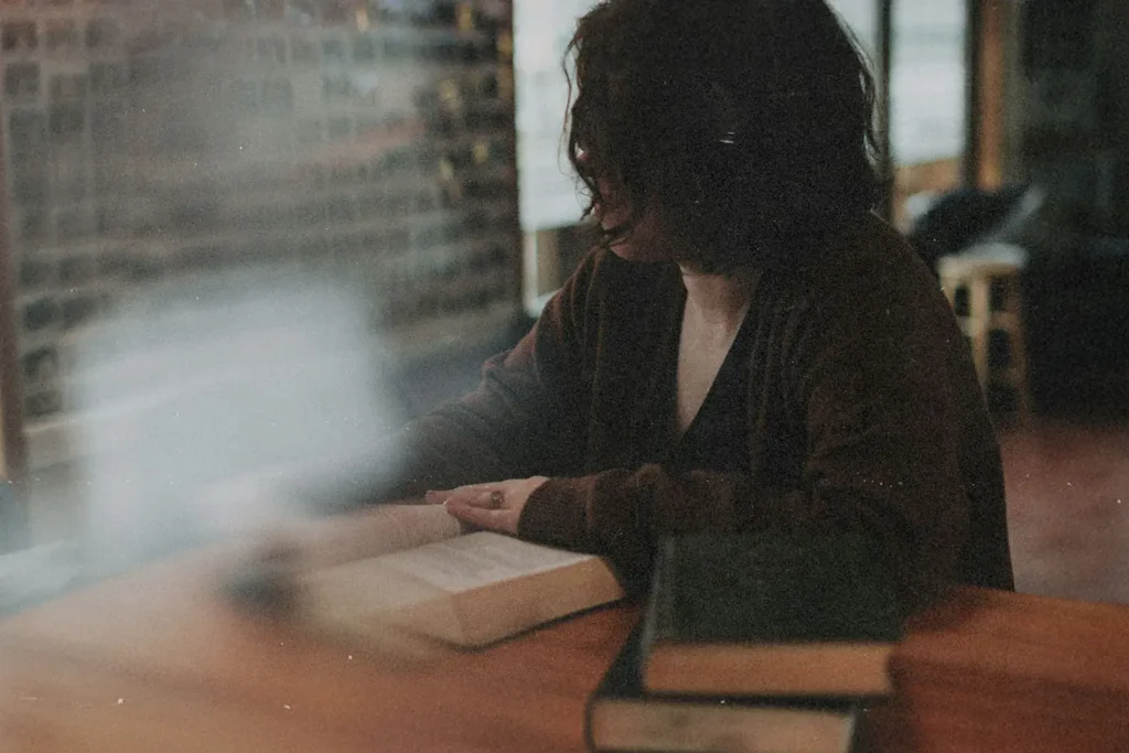 women reading a book at a wooden table