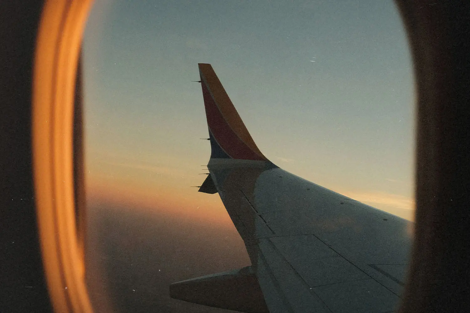 airplane wing through the window of the airplane