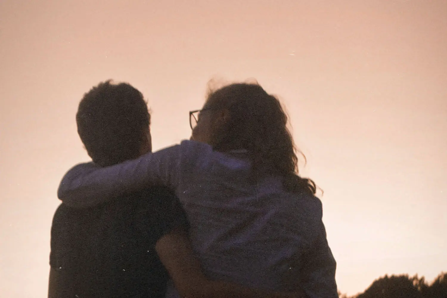 A couple with arms around each other