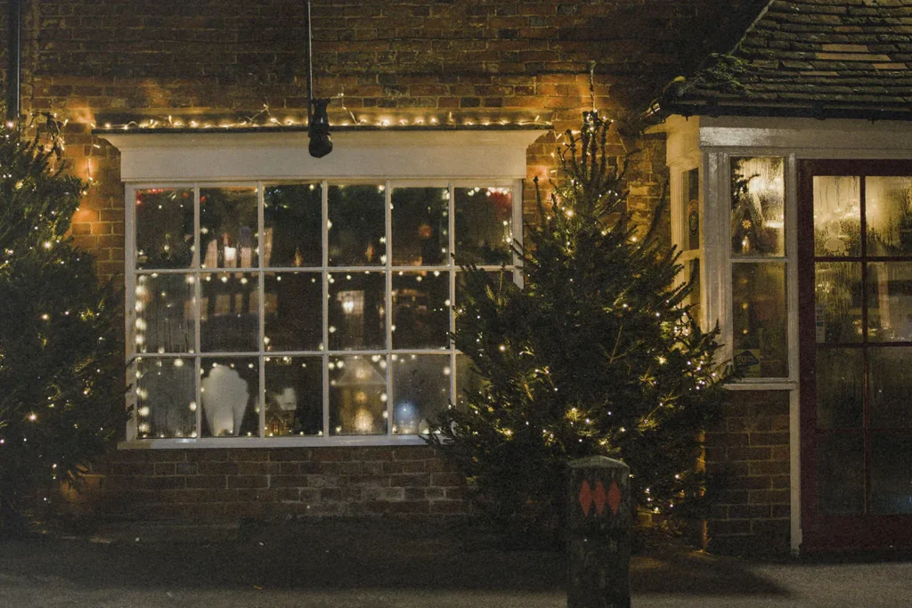 Love-Wins-This-Christmas-KCM - KCM Blog Tree and window with hanging Christmas lights