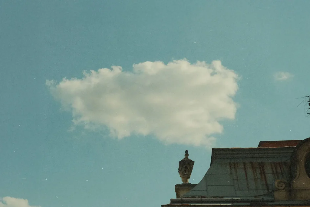 Special-Message-To-KCM-Partners-and-Friends-Ukraine - KCM Blog Single cloud in the sky behind building roof