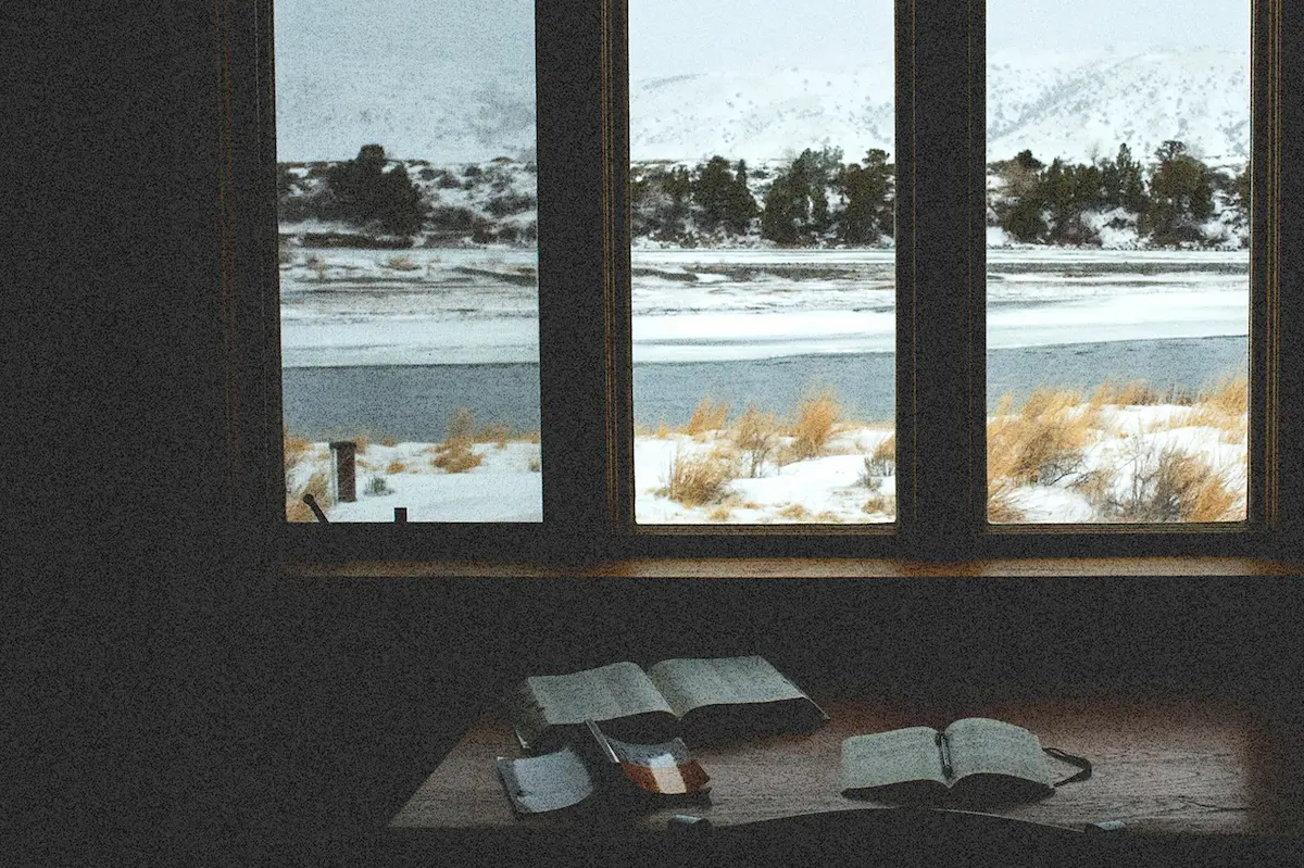 Peaceful winter view with open Bible and journal, inspiring New Year prayer habits and spiritual reflection.