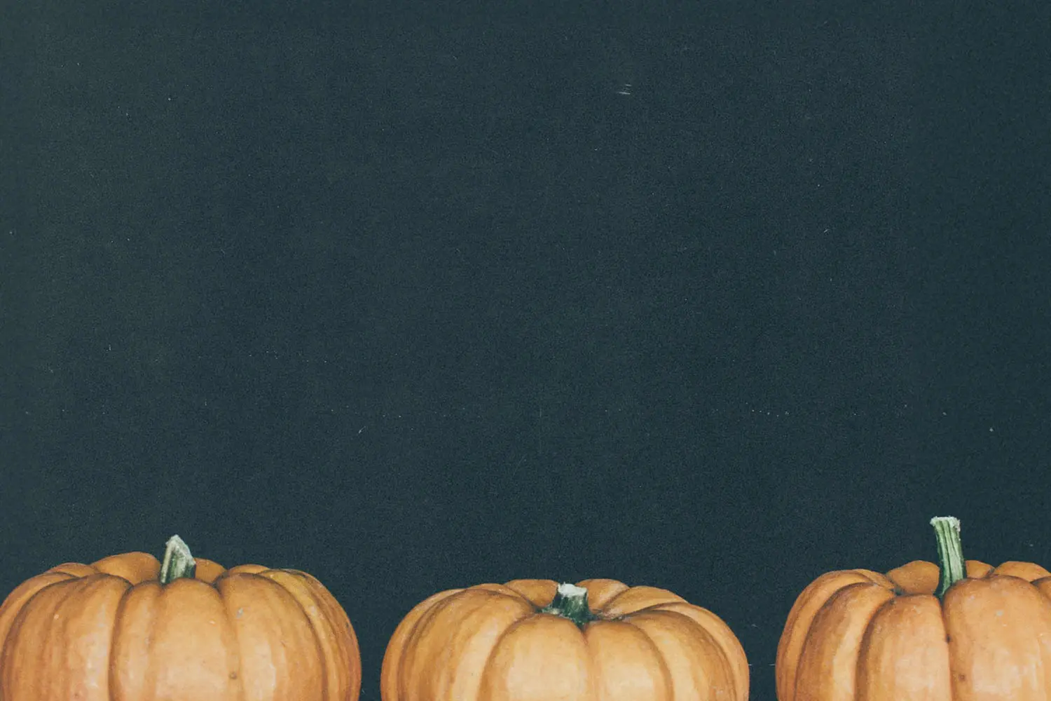 three pumpkins with black background
