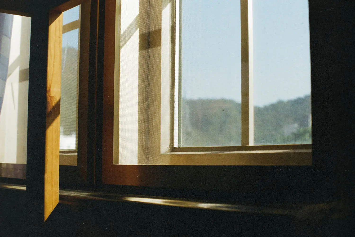 sun shining into a wooden window