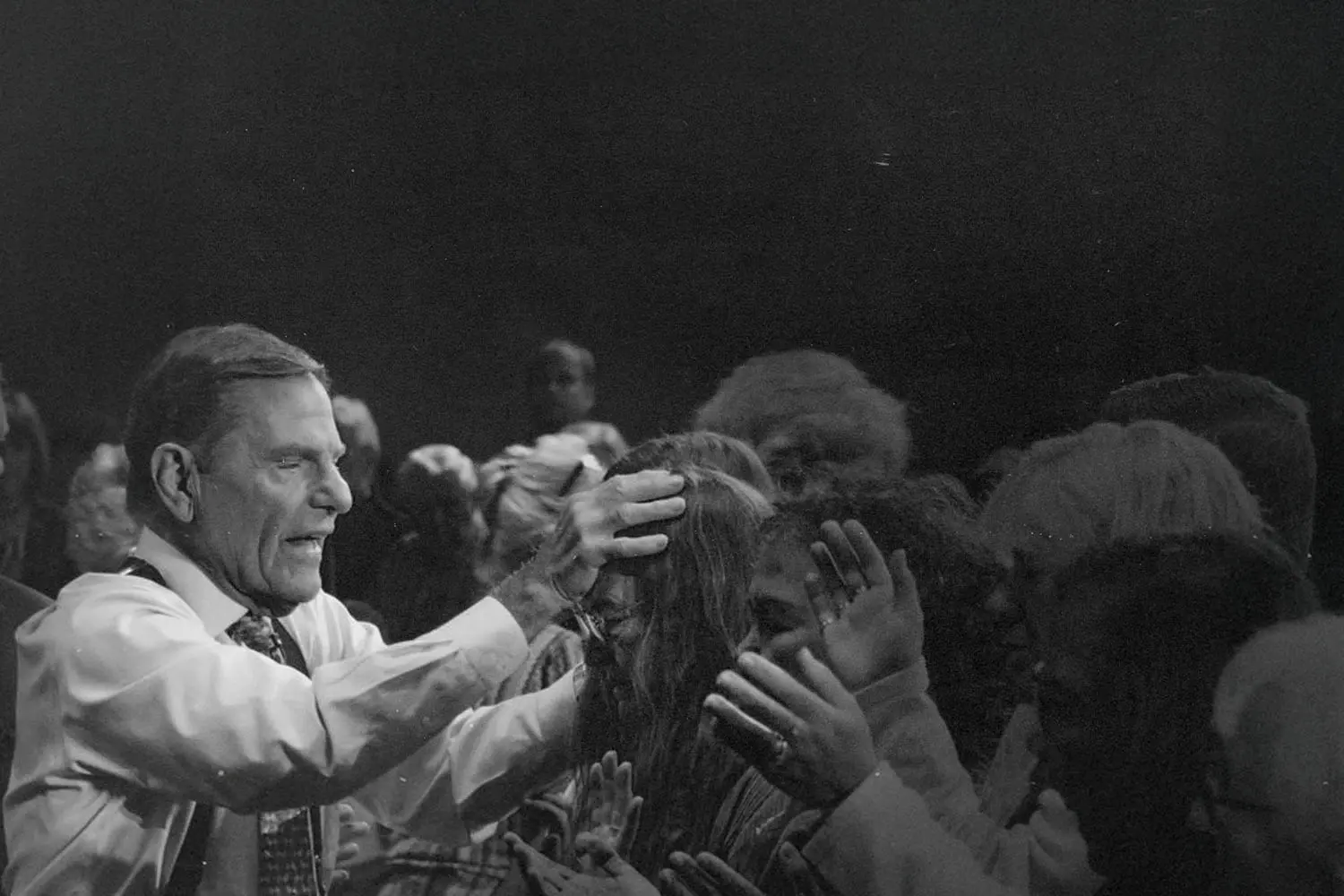 Kenneth Copeland praying over people