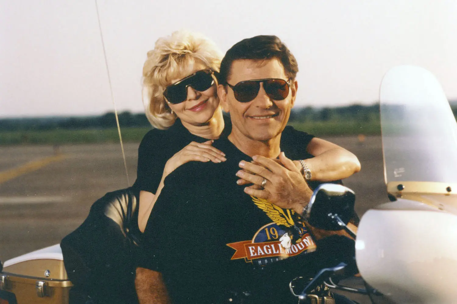 Kenneth and Gloria Copeland hugging on a motorcycle