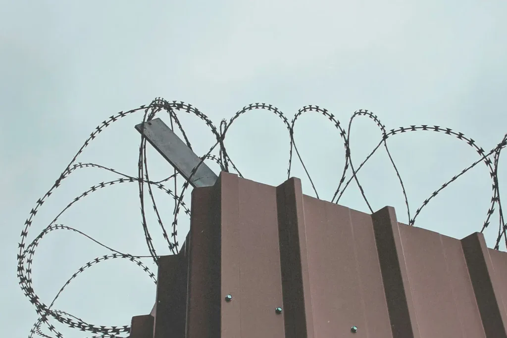 20191128-Grace-on-Death-Row-KCM-Blog - KCM Blog barbed wire atop a steel fence