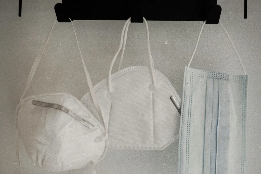 three hanging face masks