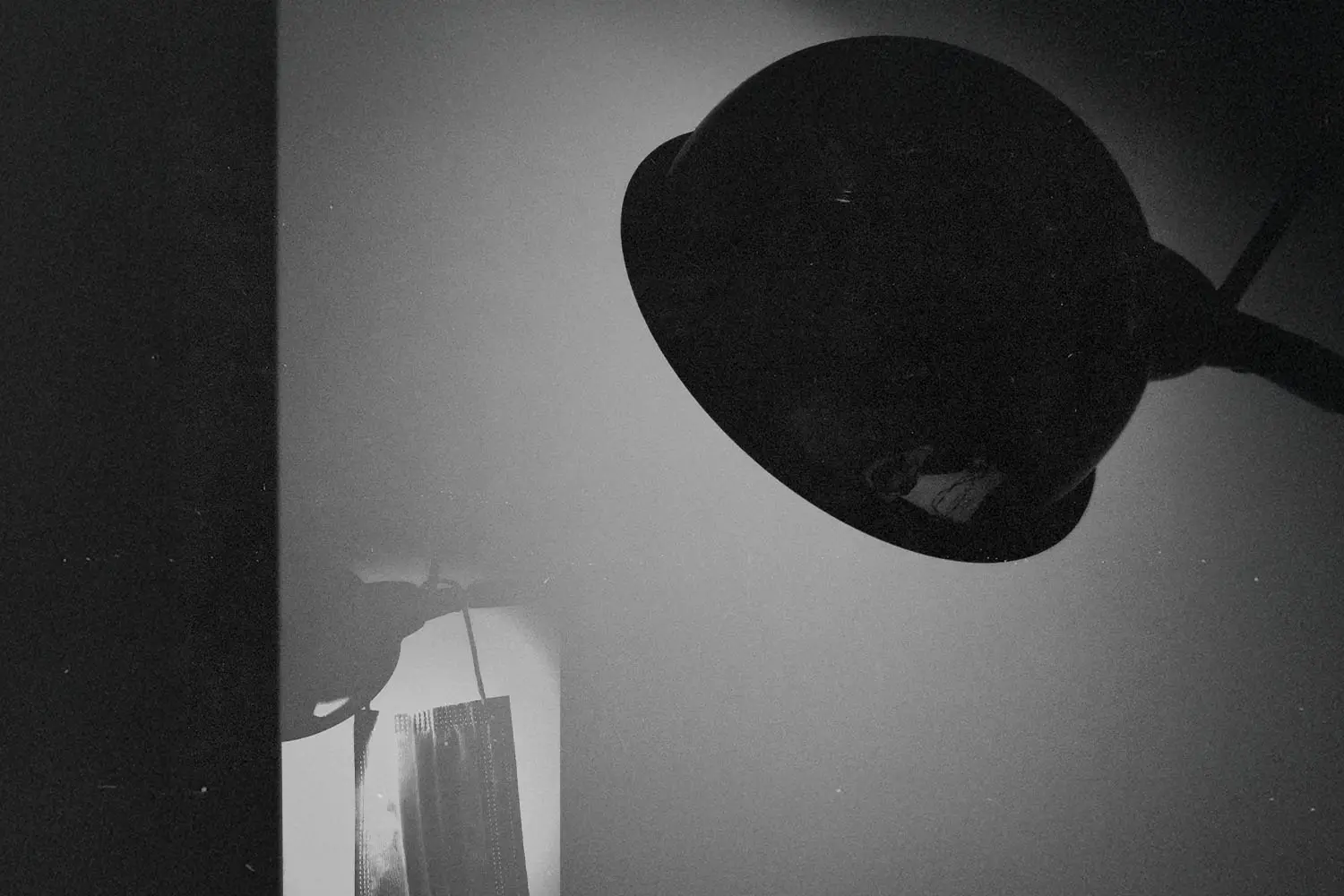 harsh spotlight luminates a paper face mask