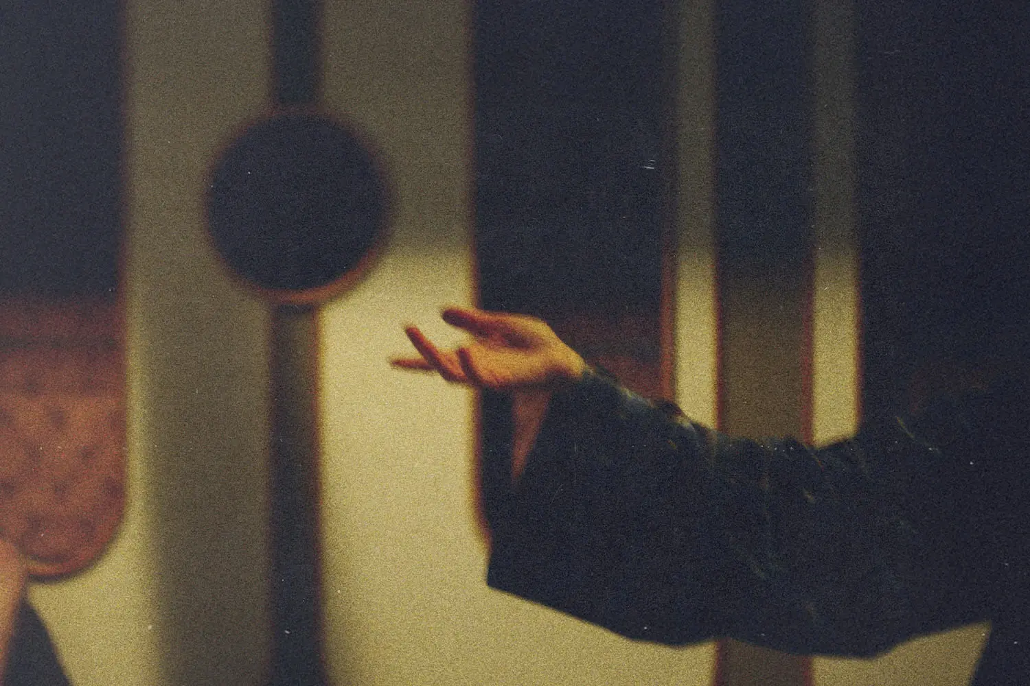 Outstretched hand in soft, warm light with blurred background elements