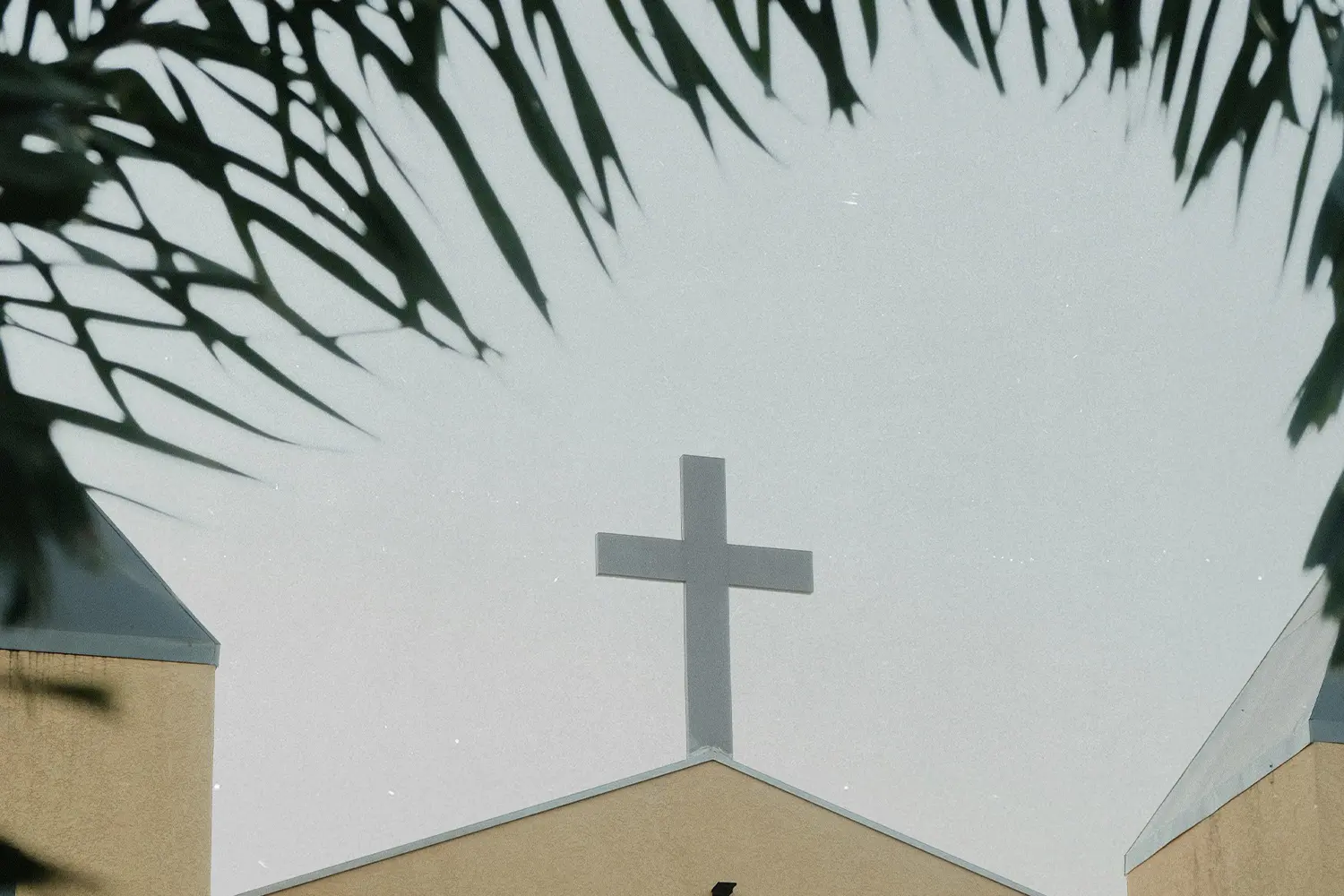 Cross sign on top of building roof