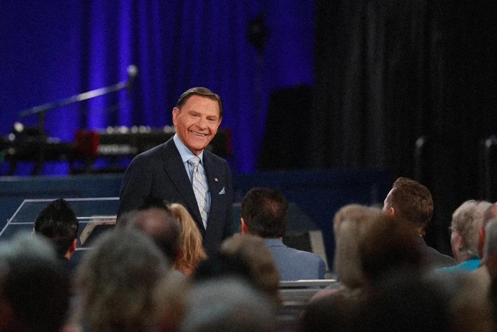 Kenneth Copeland smiling at a congregation