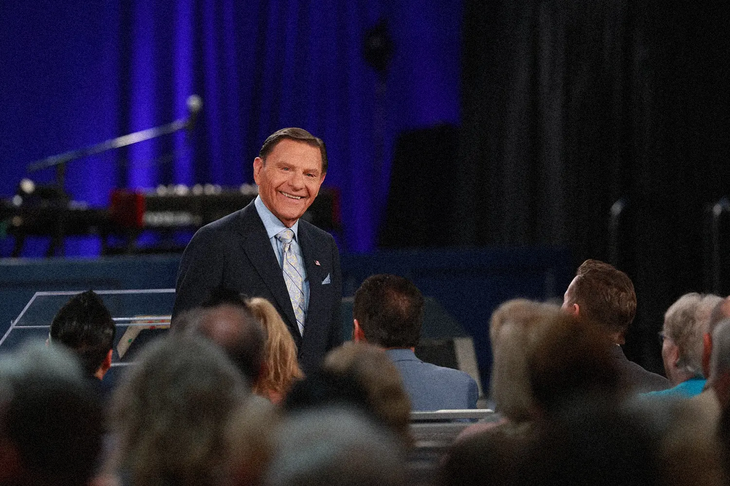 Kenneth Copeland smiling at a congregation