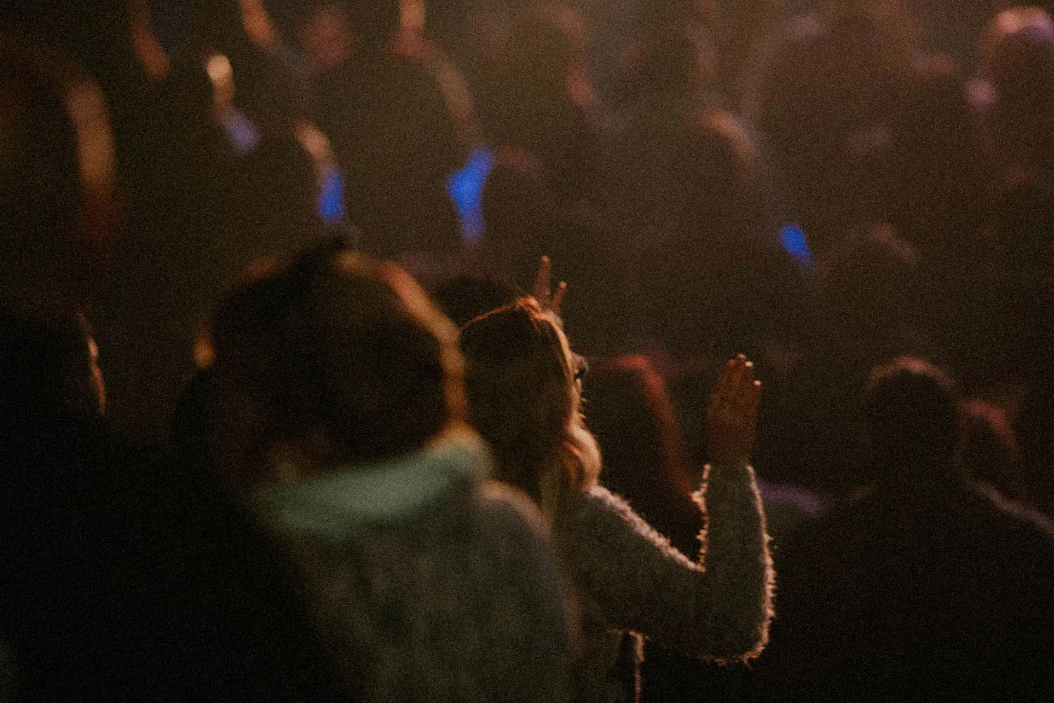 crowd with hands raised in worship