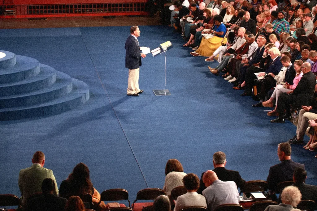 Kenneth Copeland standing at the podium talking to an audience