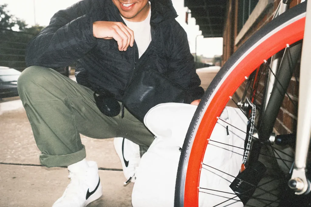 Man squatting posed next to a bike tire