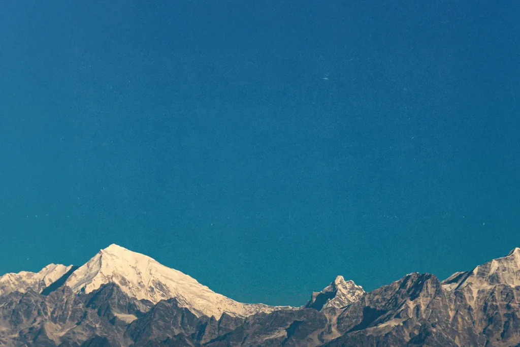 View of snowy mountains with a clear blue sky in the background
