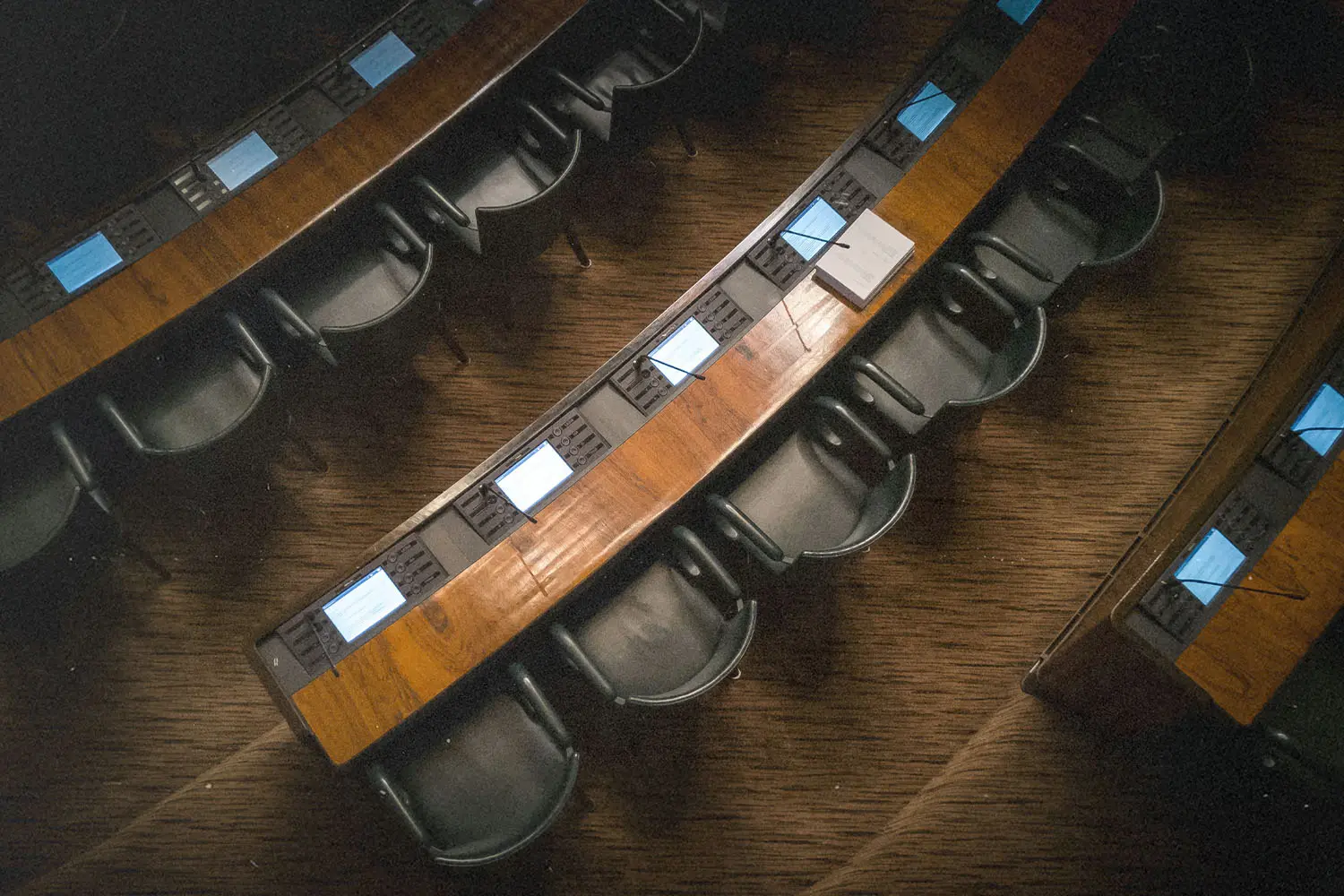 Row of college lecture room chairs and desks