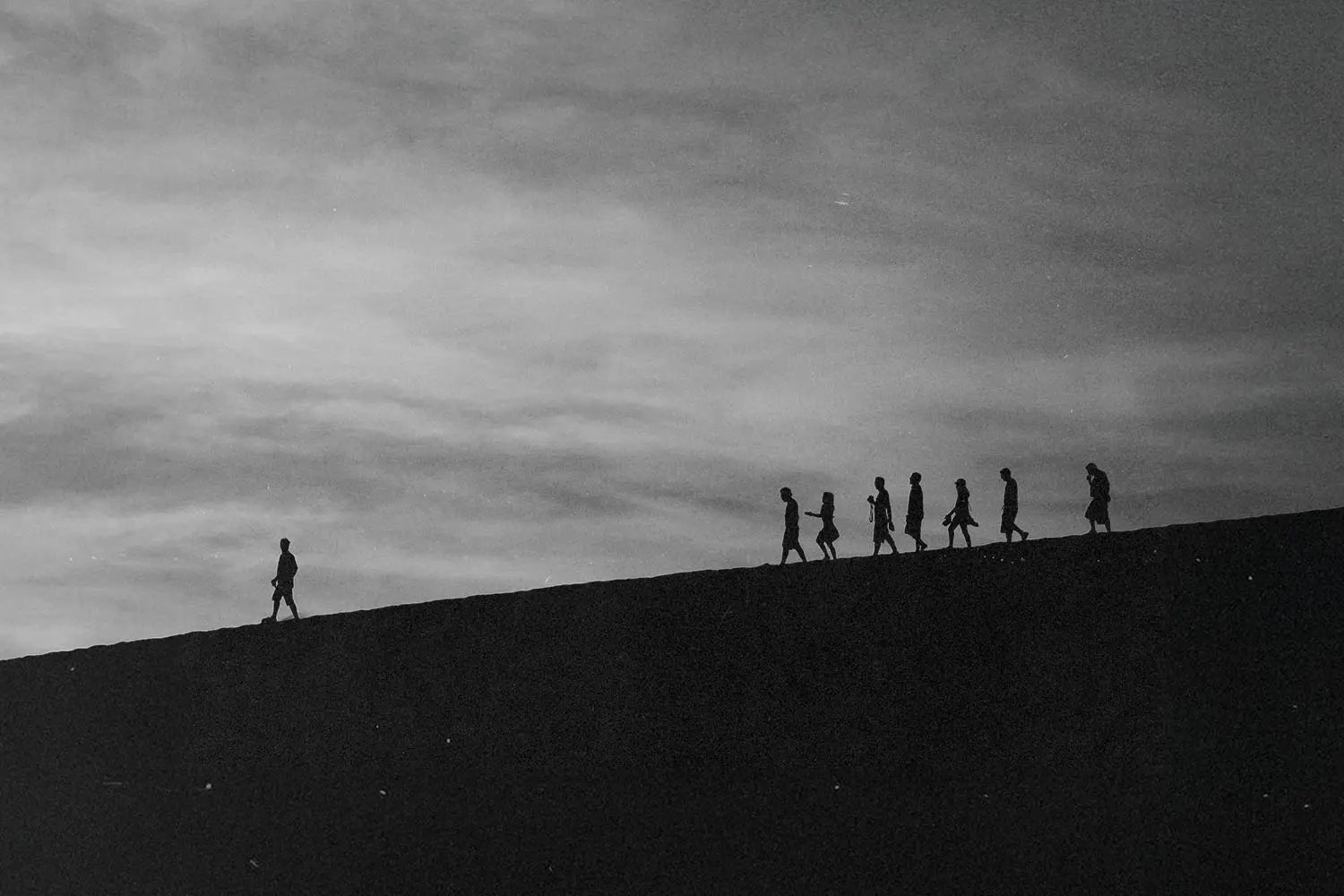 Person walking ahead leading a group of people