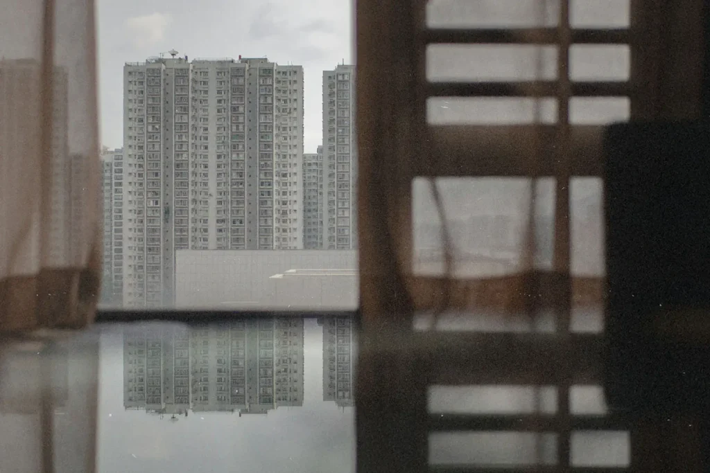 20250618-Empowering-East-Asian-Leaders-With-the-Gospel-KCM - KCM Blog Window with curtains looking out to a body of water and apartment buildings in the distant background