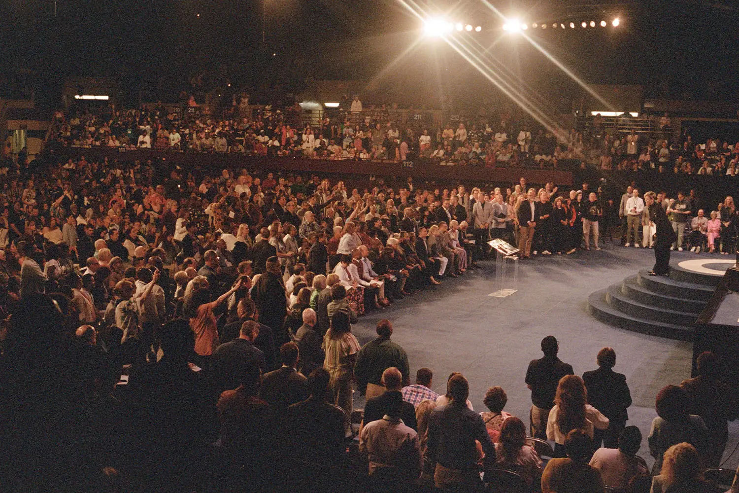 Audience of people watching Kenneth Copeland preach from stage at Southwest Believers' Convention