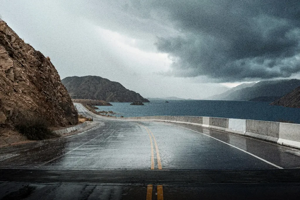 A stormy coastal road beneath dark clouds symbolizes enforcing the authority of God to speak peace and protection when life’s circumstances rise against you.